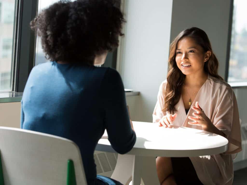 women talking at work in a workplace with diversity